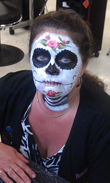 Day of dead face painted of a skull and flowers