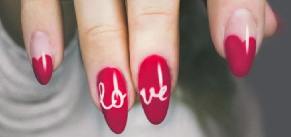 pink pointed nails with love written on them